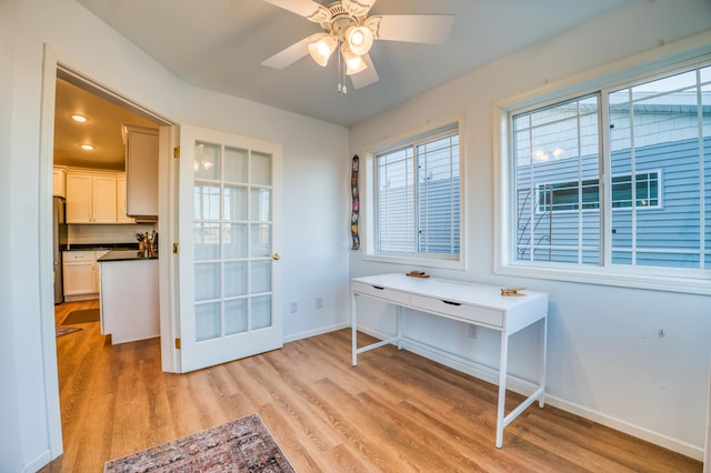 interior space with ceiling fan and light hardwood / wood-style flooring