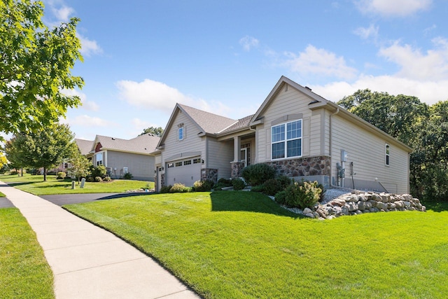 view of front of property with a garage and a front lawn