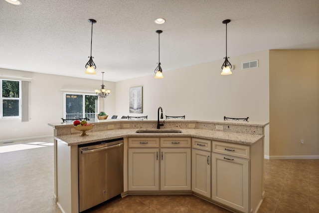 kitchen featuring sink, stainless steel dishwasher, a notable chandelier, pendant lighting, and a kitchen island with sink