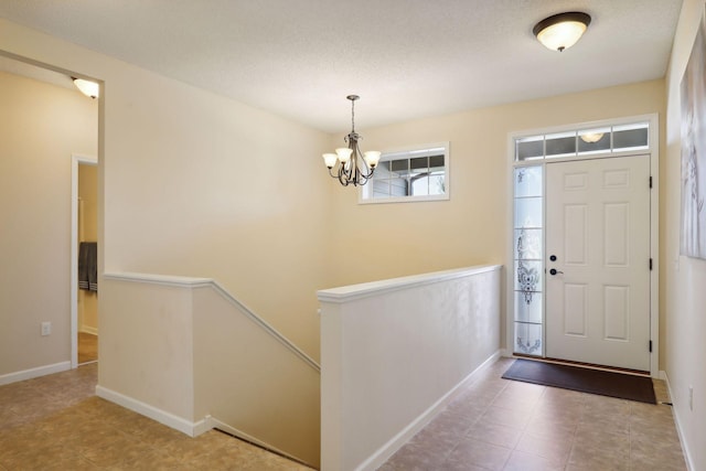 entryway featuring an inviting chandelier