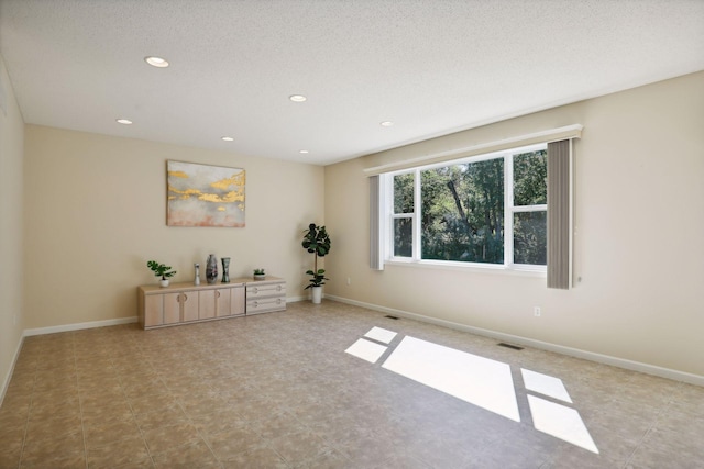 empty room featuring a textured ceiling