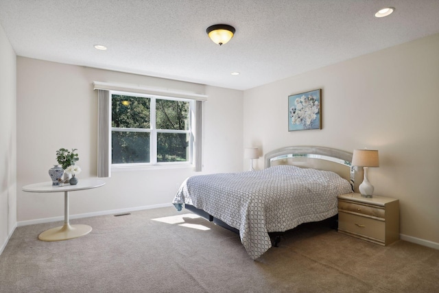 bedroom featuring carpet flooring and a textured ceiling