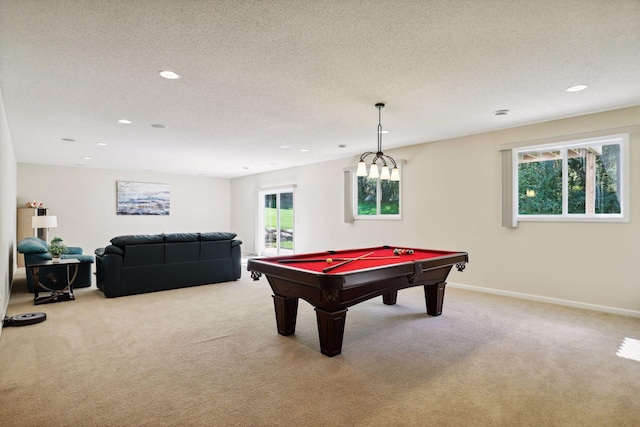 recreation room with light colored carpet, a textured ceiling, and billiards