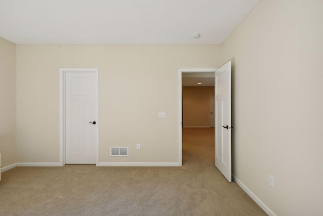 empty room featuring light colored carpet