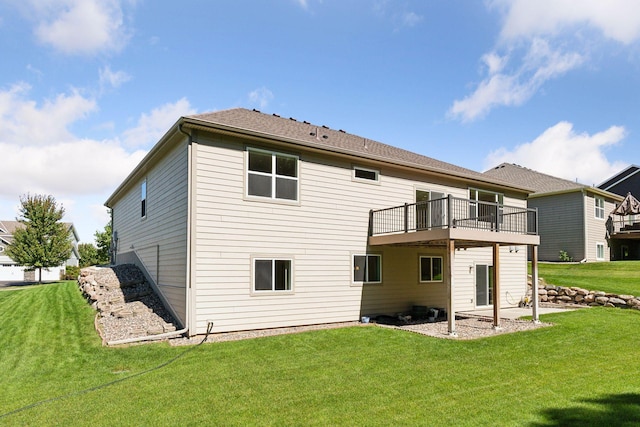 rear view of property featuring a lawn and a wooden deck