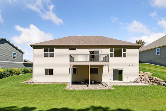 back of property featuring a patio area and a lawn