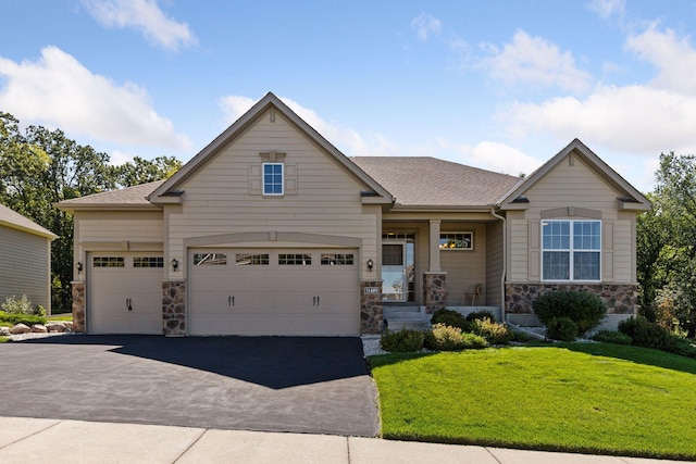 craftsman-style home featuring a front yard and a garage