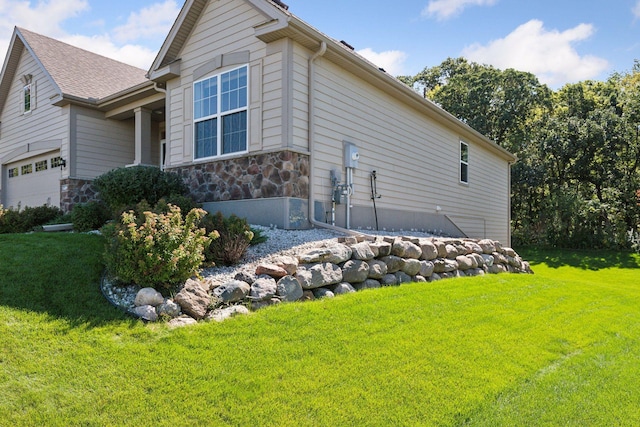 view of property exterior with a lawn and a garage