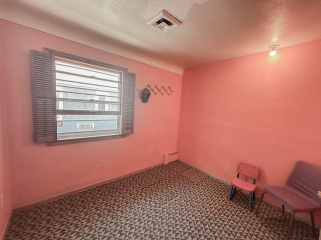 spare room featuring a baseboard heating unit