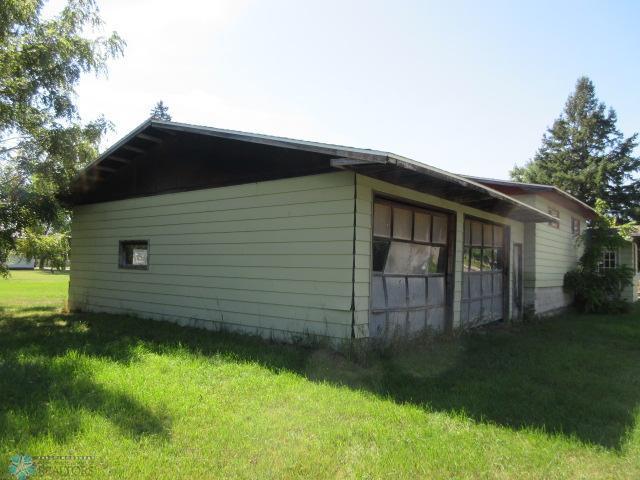 view of side of property with a lawn