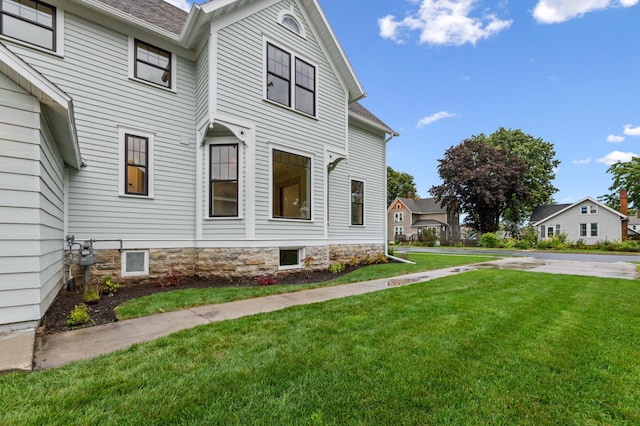 view of side of home featuring a lawn