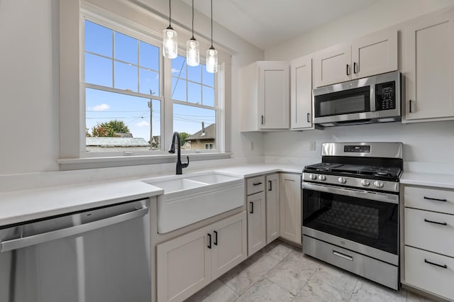 kitchen featuring light countertops, stainless steel appliances, marble finish floor, and a sink
