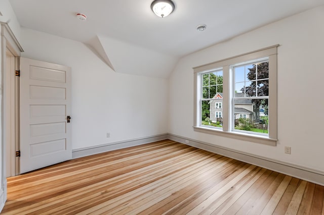 bonus room with vaulted ceiling, baseboards, and hardwood / wood-style floors
