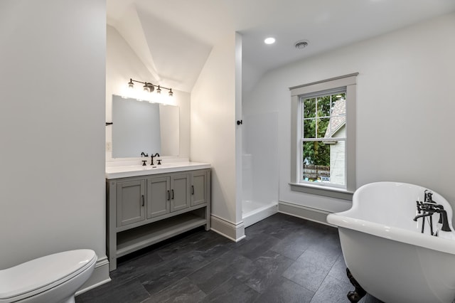 bathroom with toilet, a shower, vanity, visible vents, and a freestanding tub