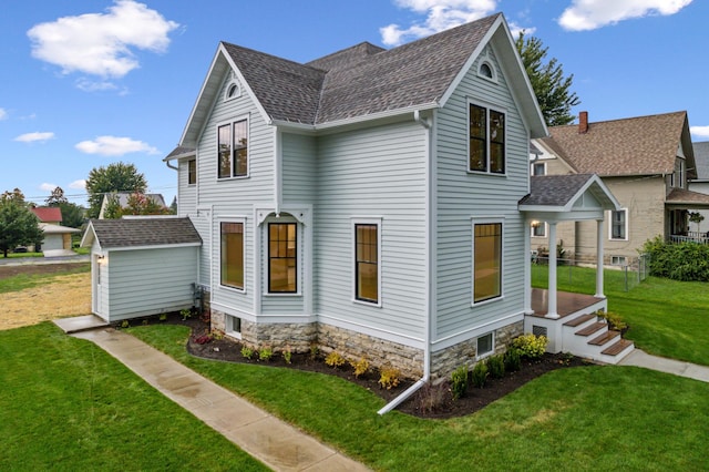 136 2nd Ave SE, Spring Grove, MN 55974 - view of property exterior with a yard, a shingled roof, and an outdoor structure