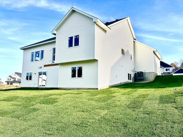 rear view of property with a lawn