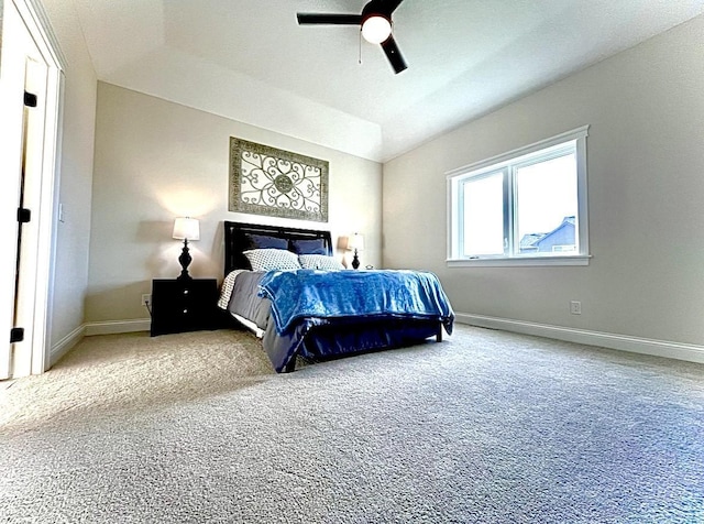 carpeted bedroom with ceiling fan and vaulted ceiling