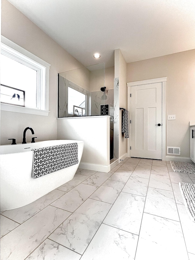 bathroom featuring separate shower and tub