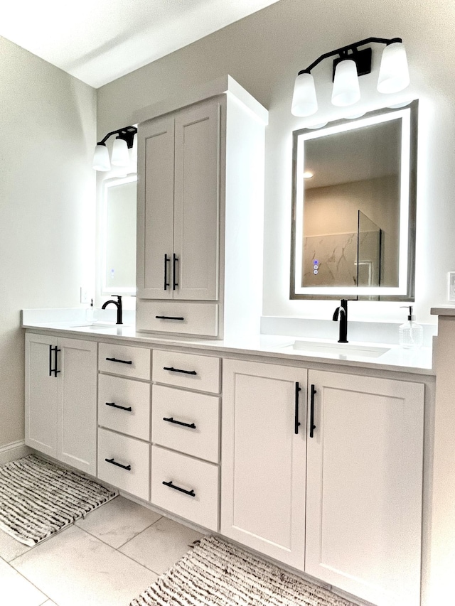 bathroom with a shower, vanity, and tile patterned flooring