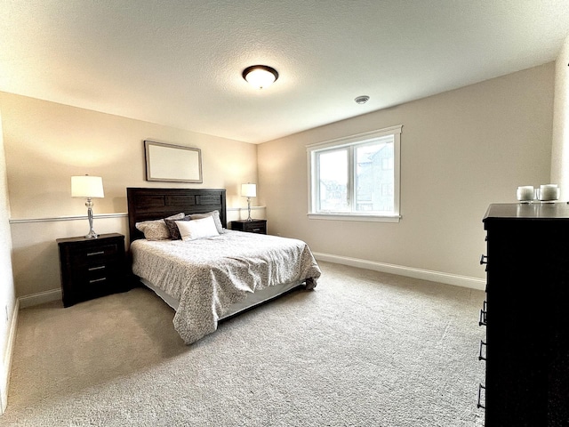 bedroom with carpet and a textured ceiling