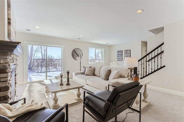 living room with a fireplace and light carpet