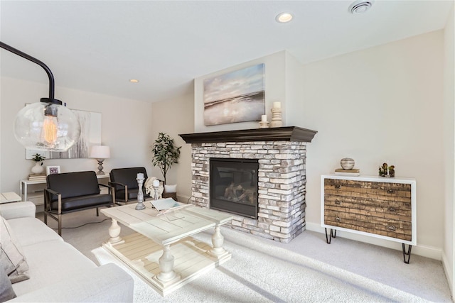 living room with a stone fireplace and light carpet