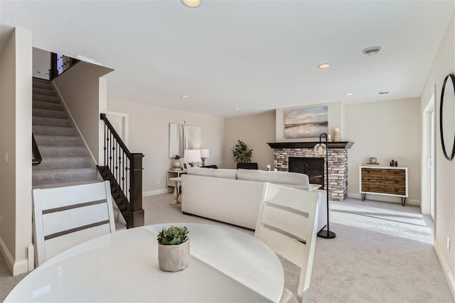 carpeted dining room featuring a fireplace