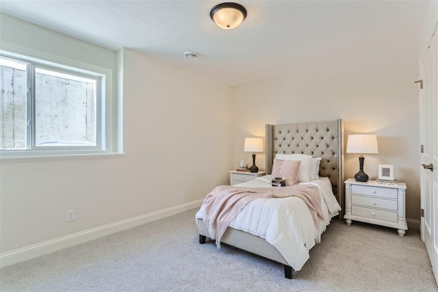 bedroom with light colored carpet