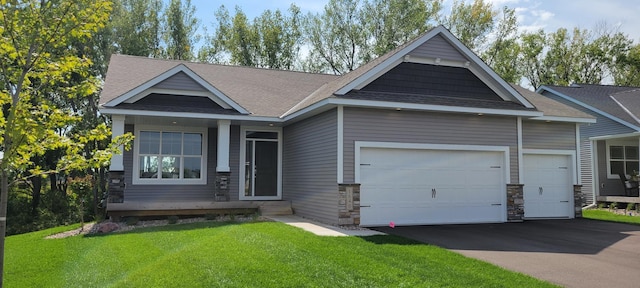 craftsman-style home featuring a garage and a front yard