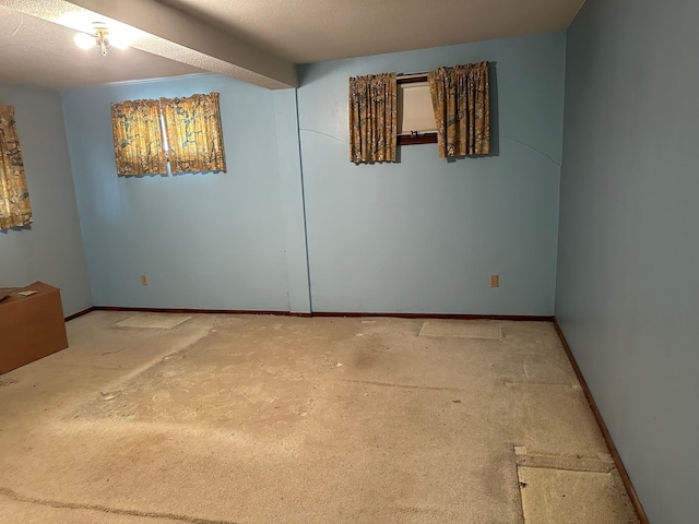 unfurnished room with a textured ceiling