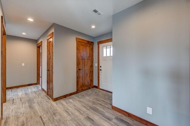 foyer entrance with light hardwood / wood-style floors