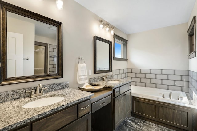 bathroom with vanity, decorative backsplash, and a washtub