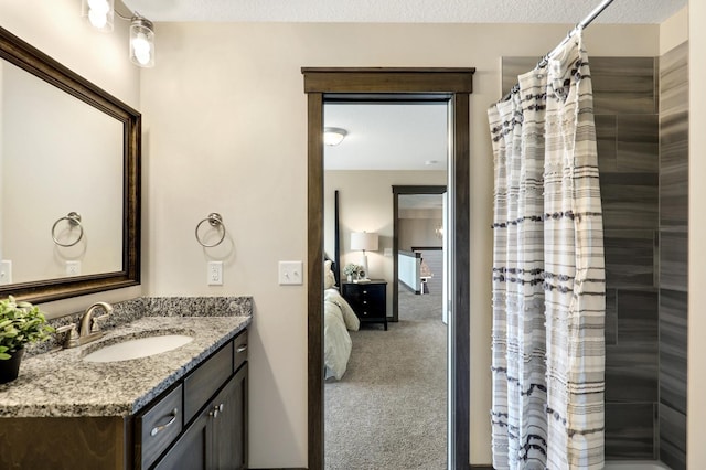 bathroom featuring walk in shower, a textured ceiling, and vanity