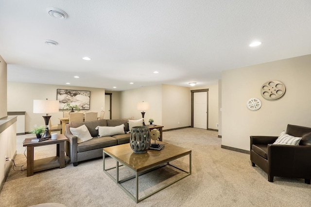 carpeted living room with a textured ceiling