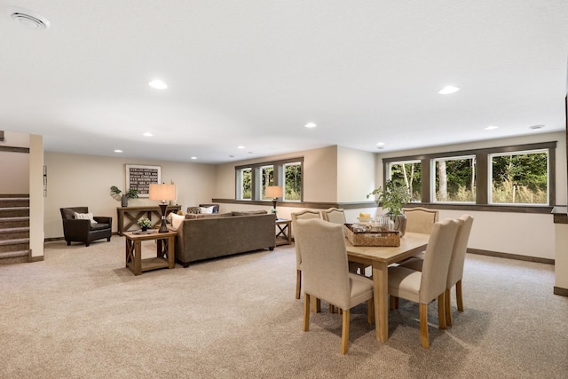 dining area featuring light colored carpet