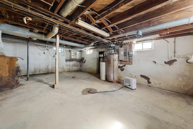 basement with electric panel and gas water heater