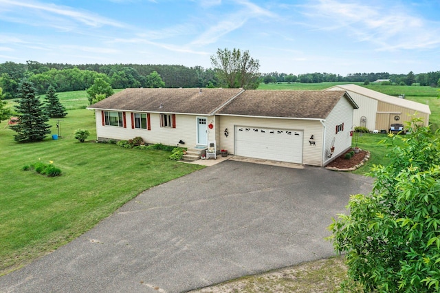 7702 County Road 5 NE, North Branch, MN 55056 - ranch-style house with an attached garage, asphalt driveway, a front lawn, and roof with shingles