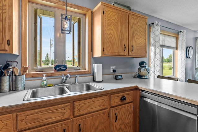 7702 County Road 5 NE, North Branch, MN 55056 - kitchen with stainless steel dishwasher, light countertops, a textured ceiling, and brown cabinets