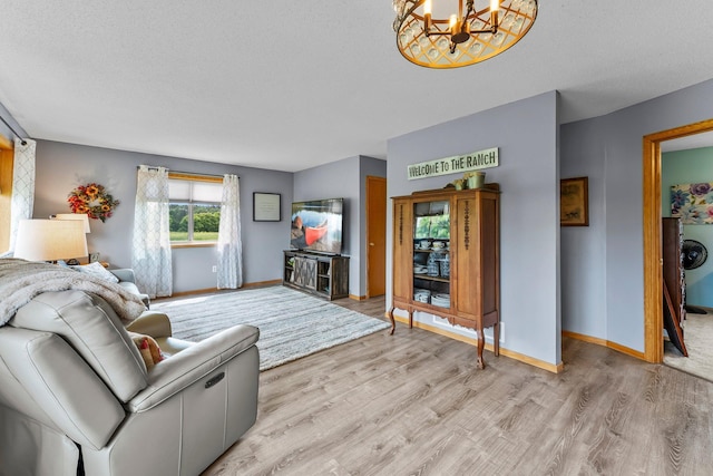 7702 County Road 5 NE, North Branch, MN 55056 - living area with light wood-style flooring, a chandelier, and a textured ceiling