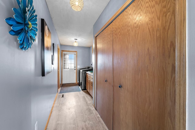 7702 County Road 5 NE, North Branch, MN 55056 - hallway with light wood-style flooring and washer and dryer