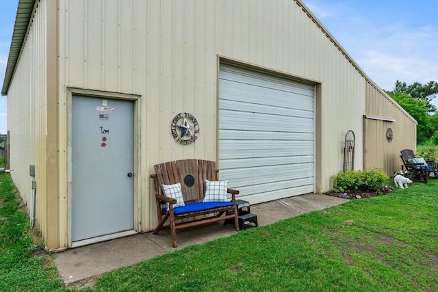 7702 County Road 5 NE, North Branch, MN 55056 - view of exterior entry featuring a detached garage and a yard