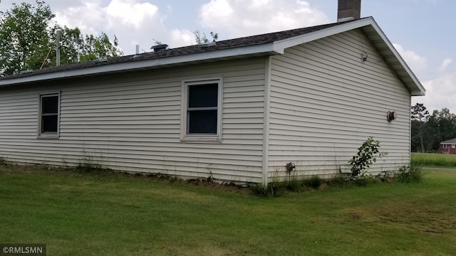 view of side of property with a lawn