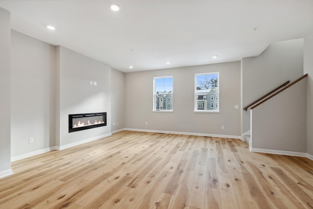 unfurnished living room with light hardwood / wood-style floors