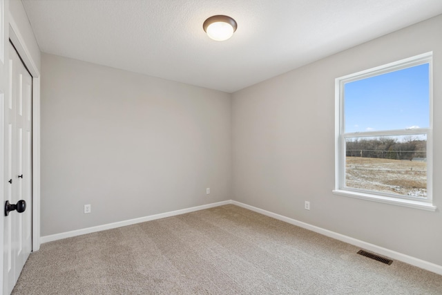 unfurnished bedroom featuring carpet and a closet