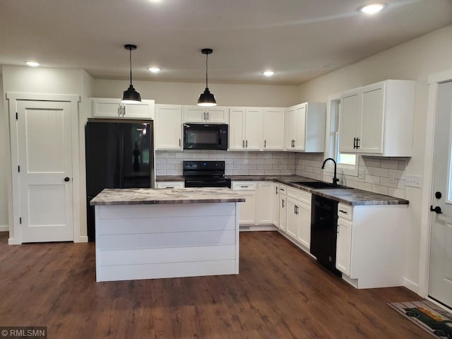 kitchen featuring white cabinets, sink, hanging light fixtures, and black appliances