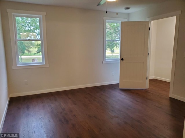 spare room featuring dark hardwood / wood-style flooring and ceiling fan