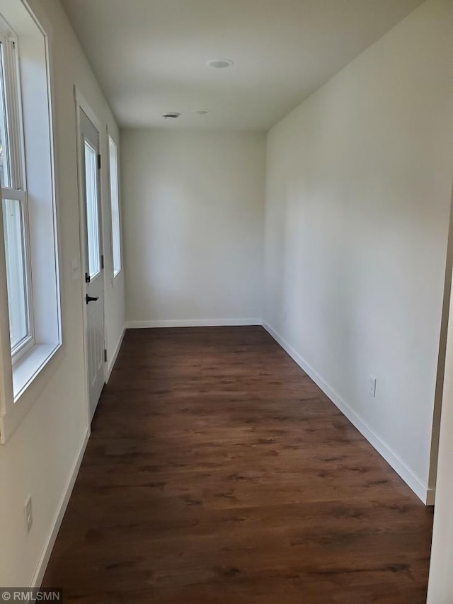 empty room with dark hardwood / wood-style floors