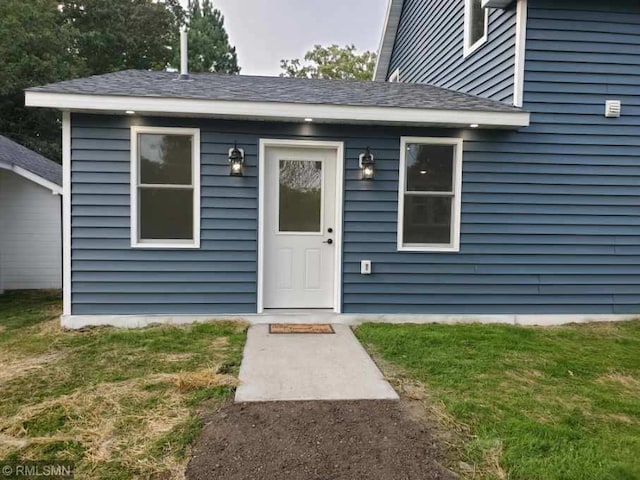 doorway to property featuring a yard