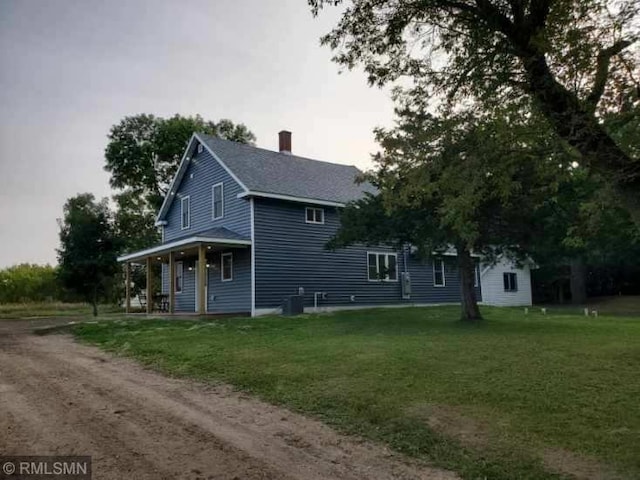 view of side of home with a lawn