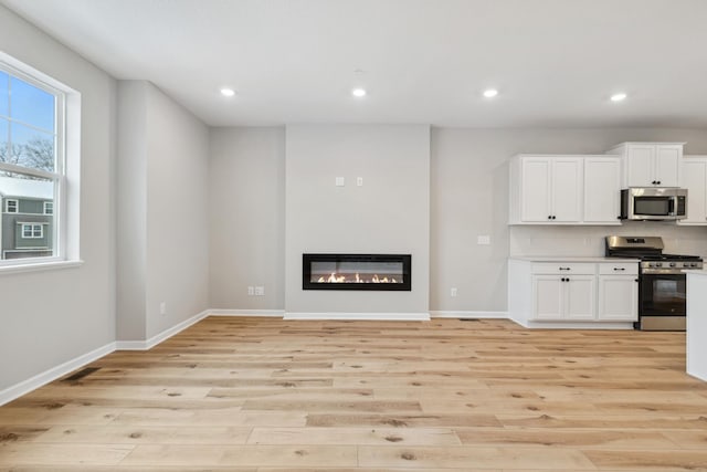 unfurnished living room with light hardwood / wood-style floors